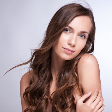 Beautiful woman with long brown hair. Closeup portrait of a fash clipart