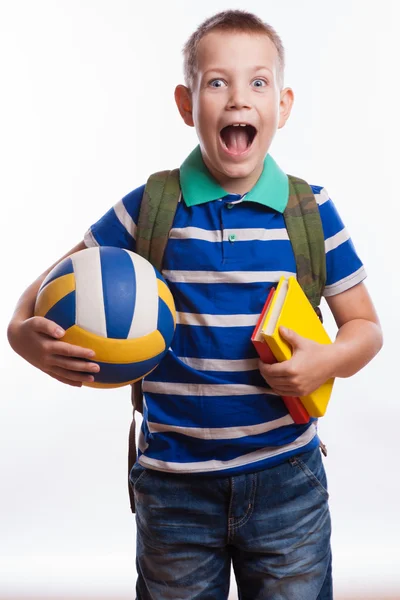 Menino feliz com mochila, bola e livros isolados em fundo branco — Fotografia de Stock