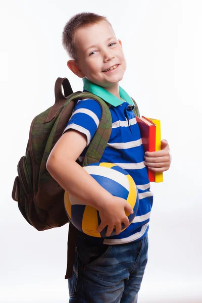 Menino feliz com mochila, bola e livros isolados em fundo branco — Fotografia de Stock