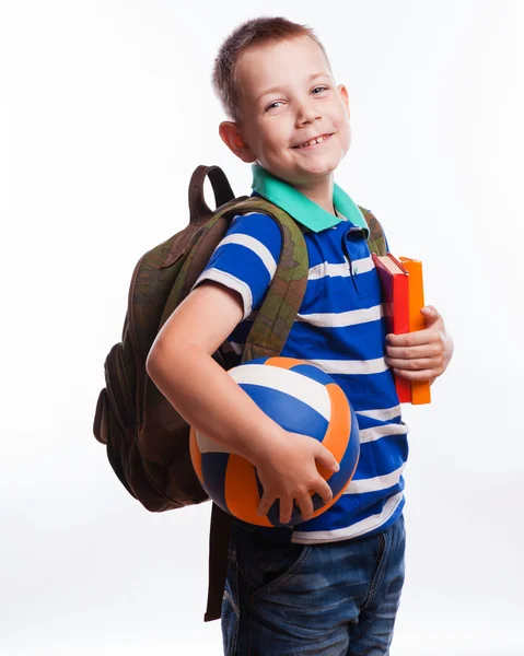 Menino feliz com mochila, bola e livros isolados em branco Fotos De Bancos De Imagens Sem Royalties