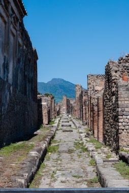 Pompeii is a ruined and partially buried Roman town-city near modern Naples in the Italian region of Campania, in the territory of the comune of Pompei..