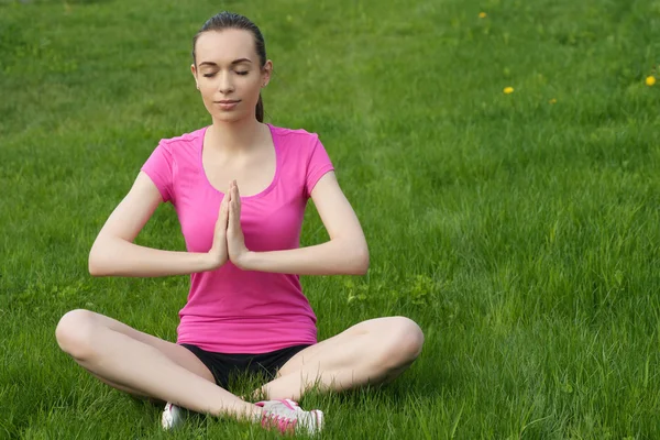 Genç Kız parkta yoga yaparken — Stok fotoğraf