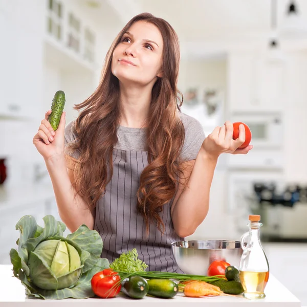 年轻的女人在厨房里做饭。健康食品-蔬菜萨尔 — 图库照片