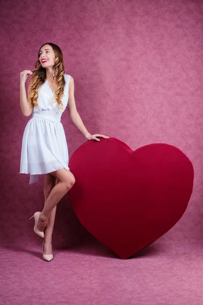 Elegant and fashion woman holding heart — Stock Photo, Image