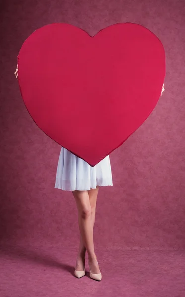 Elegant and fashion woman holding heart — Stock Photo, Image
