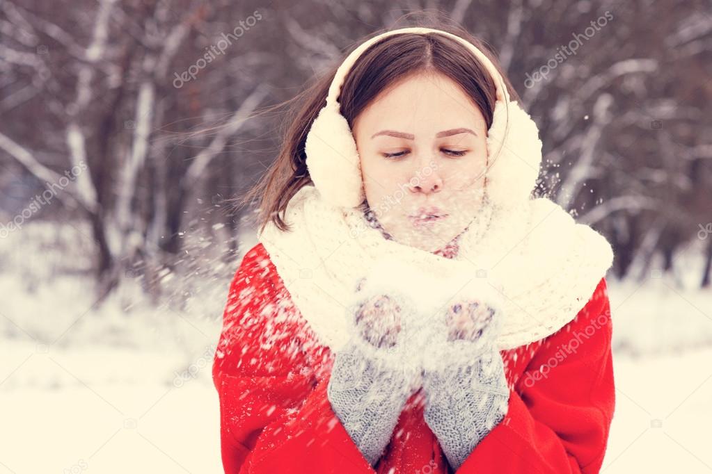 Beauty Winter Girl Blowing Snow in frosty winter Park. Outdoors. Flying ...