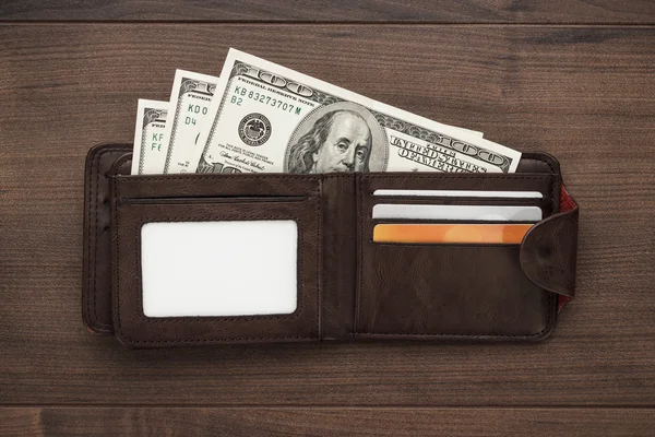 Purse with money on the wooden table — Stock Photo, Image