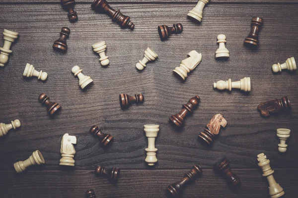 Chess figures on the brown woden table background — Stock Photo, Image