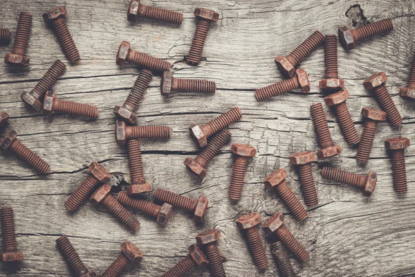 Rusty screw bolt on the wooden table — Stock Photo, Image