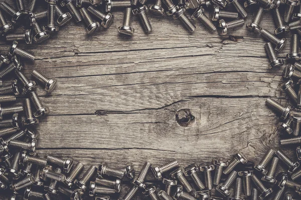 Bolts on the wooden table — Stock Photo, Image