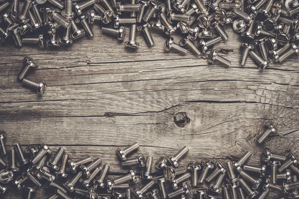 Bolts on the wooden table — Stock Photo, Image