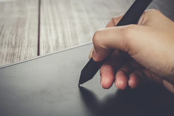 Рука дизайнера с ручкой на планшете — стоковое фото