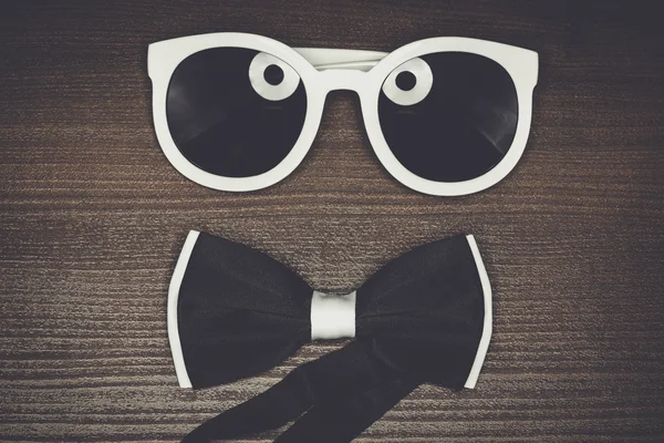 Bow tie and sunglasses on the table — Stock Photo, Image