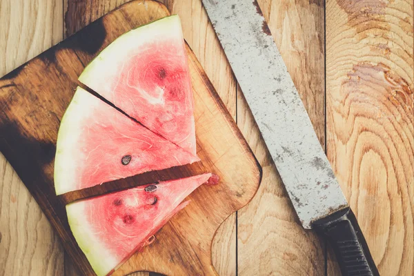 Watermelon and old knife on the table — Stock Photo, Image