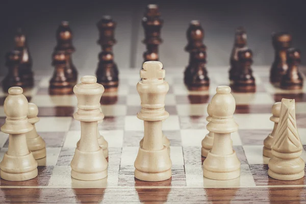 Chess board with figures on the wooden table — Stock Photo, Image