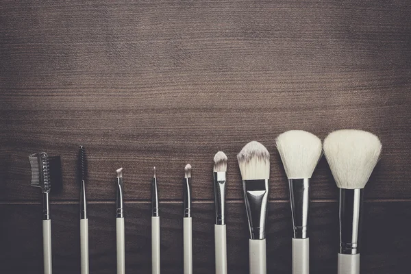 White make-up brushes on wooden background — Stock Photo, Image