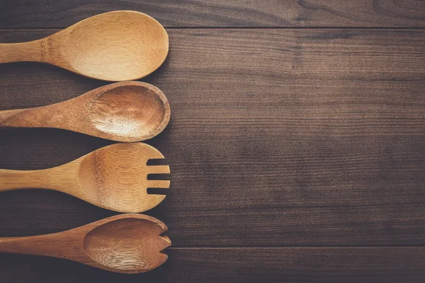 Wooden spoons on the blue table — Stock Photo, Image