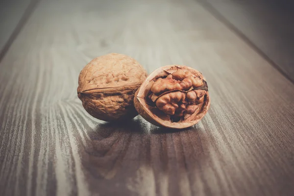 Walnuts on the brown wooden table — Stock Photo, Image