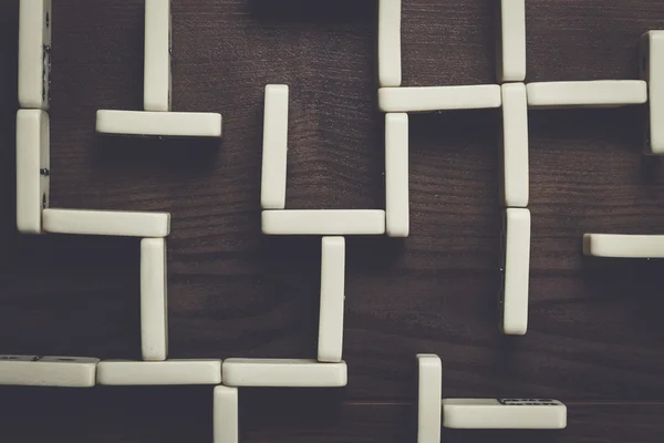 Domino peças labirinto em fundo de mesa de madeira — Fotografia de Stock