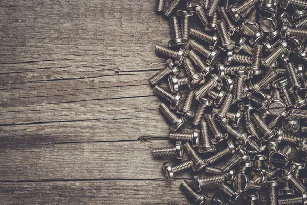 Bolts on the wooden table — Stock Photo, Image