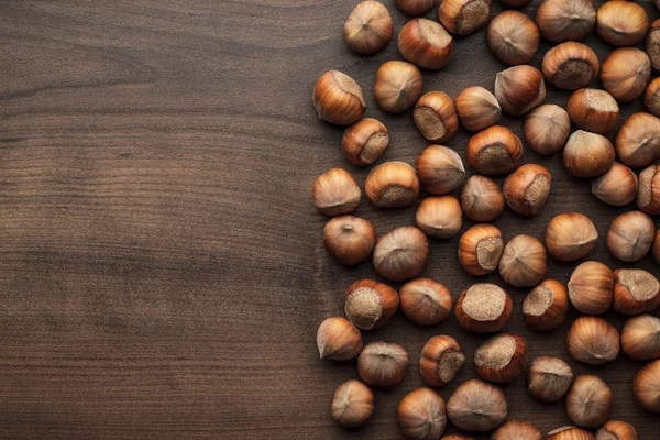 Hazelnuts on the brown wooden table — Stock Photo, Image