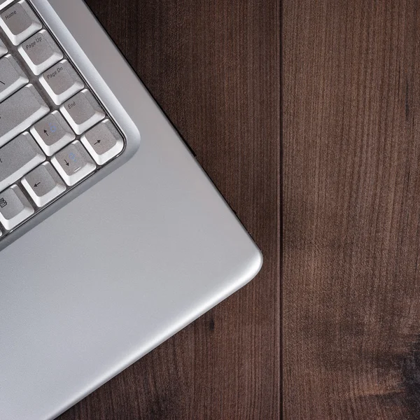 Laptop on brown wooden background — Stock Photo, Image