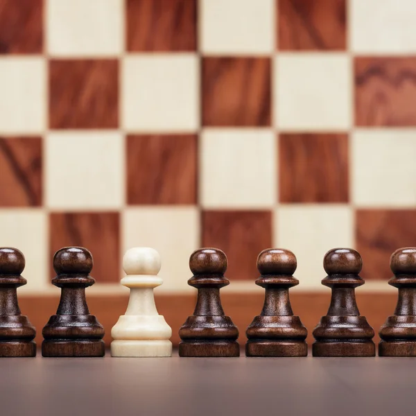 Uniqueness concept over chessboard background — Stock Photo, Image