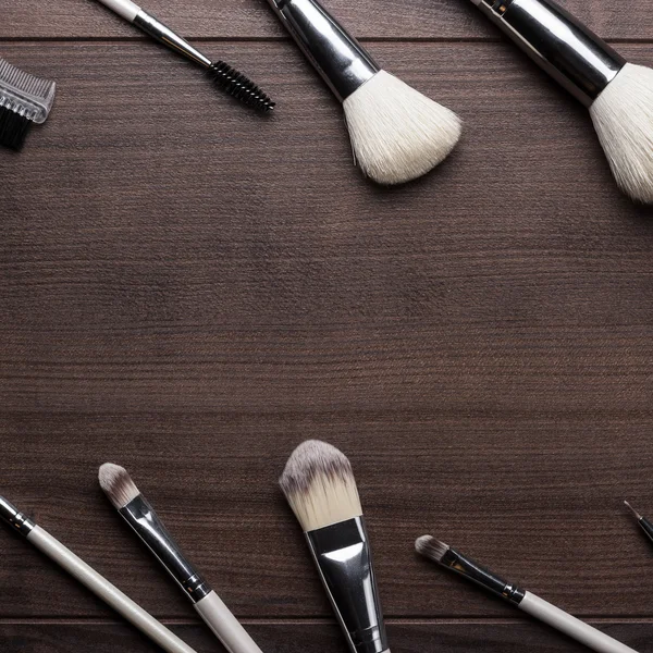 Make-up brushes on wooden background — Stock Photo, Image