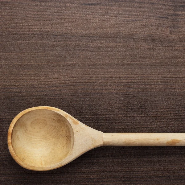 Wooden spoon on the blue table — Stock Photo, Image