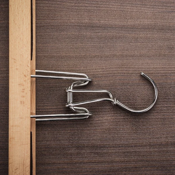 Clothing hanger on brown table — Stock Photo, Image