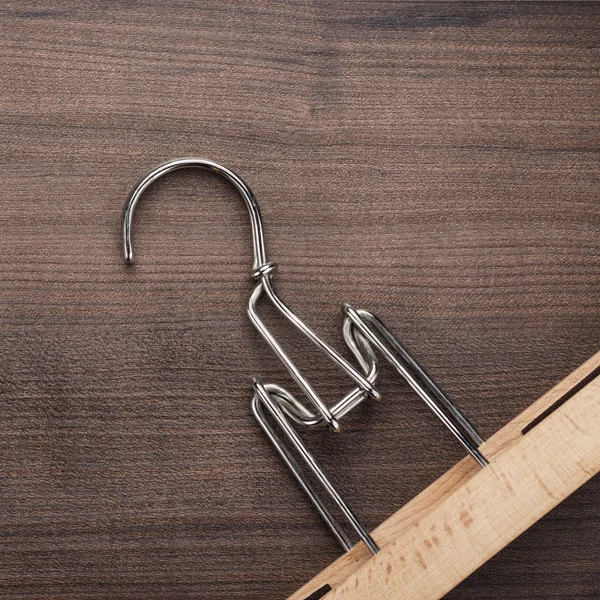 Clothing hanger on brown table — Stock Photo, Image