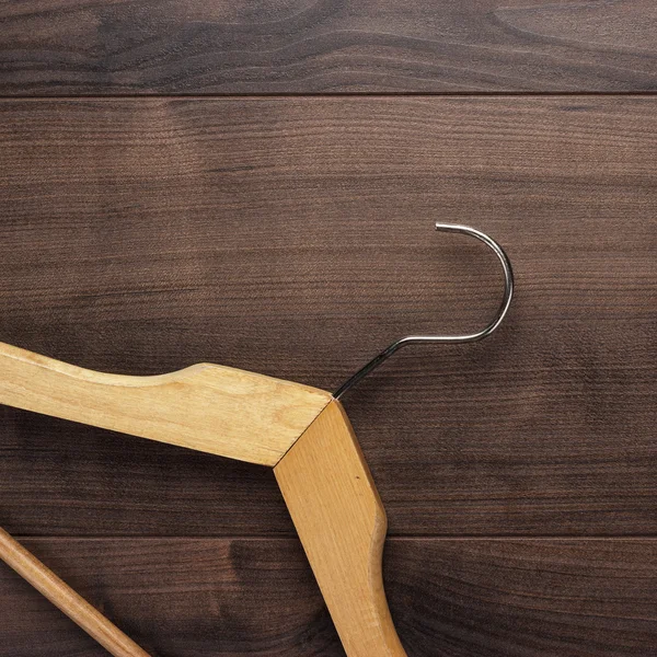 Clothing hanger on brown table — Stock Photo, Image