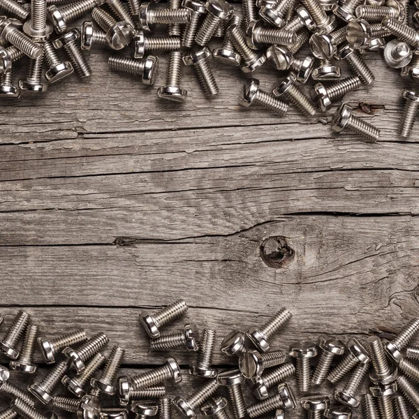 Bolts on the wooden table — Stock Photo, Image