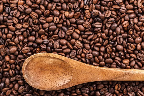 Coffee beans and wooden spoon — Stock Photo, Image