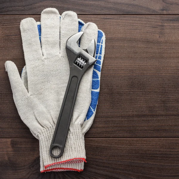 Adjustable wrench and gloves — Stock Photo, Image