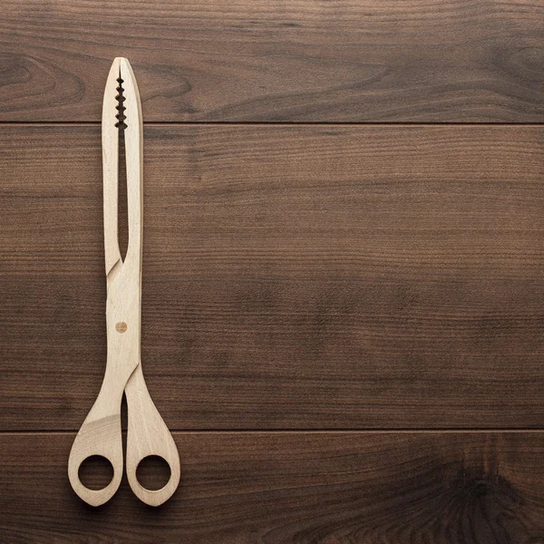 Wooden grill tongs on the table — Stock Photo, Image