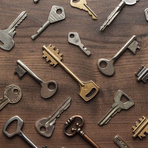 many different keys on wooden table