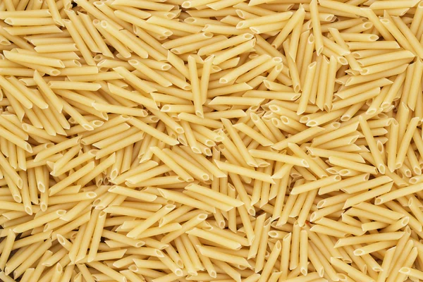 Seco penne não cozido lisce pasta textura fundo — Fotografia de Stock