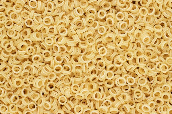 Dry uncooked anelletti pasta texture background — Stock Photo, Image