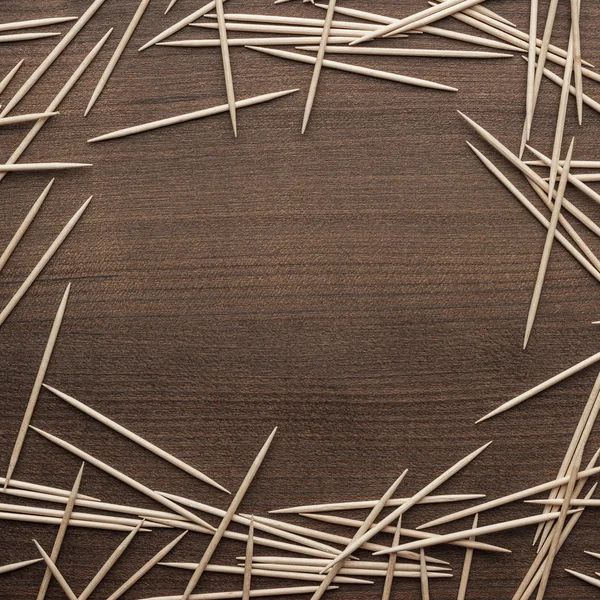 Wooden toothpicks on the table background — Stock Photo, Image