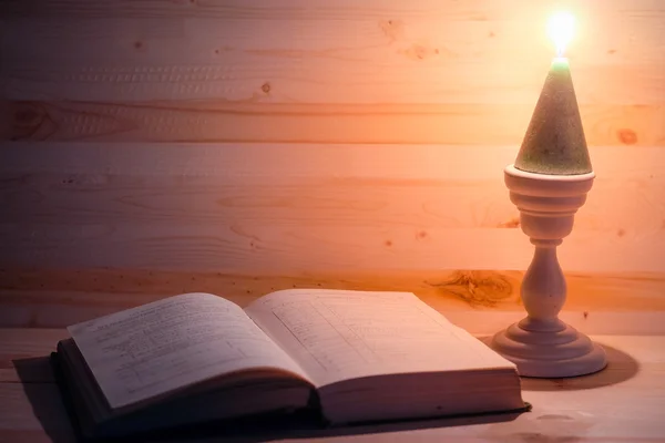 Candle and a book — Stock Photo, Image