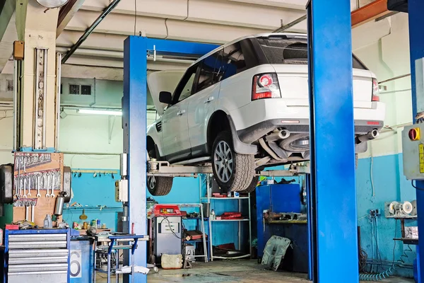 Car on a lift in a car repair station in Moscow