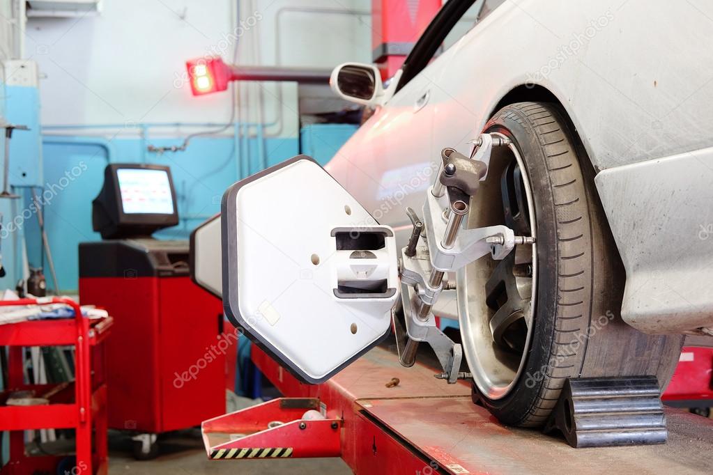 Wheel alignment equipment on a car wheel in a repair station 