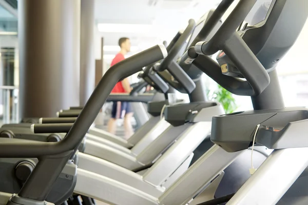 Modern fitness hall with close-up ellipticals — Stock Photo, Image