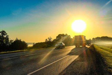 Moscow region, Russia - June, 16, 2021:  trucks on a country road in Moscow region at sunset