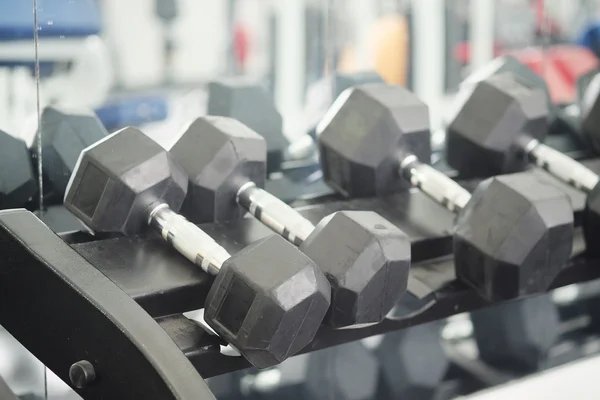 Dumbells in a rack — Stock Photo, Image