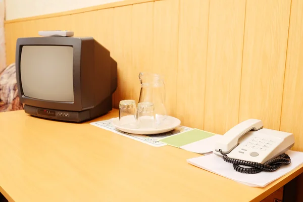 TV and a telephone on the table — Stock Photo, Image
