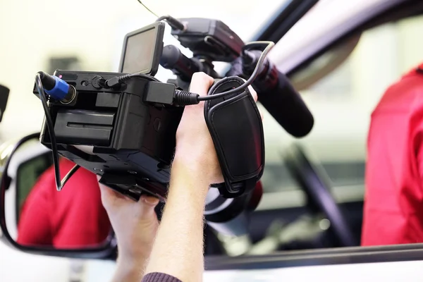 Hands holding a professional camcorder — Stock Photo, Image