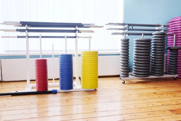 Colored barbel weights in gym — Stock Photo, Image