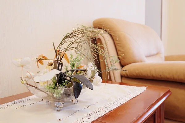 Artificial flowers in a glass vase — Stock Photo, Image